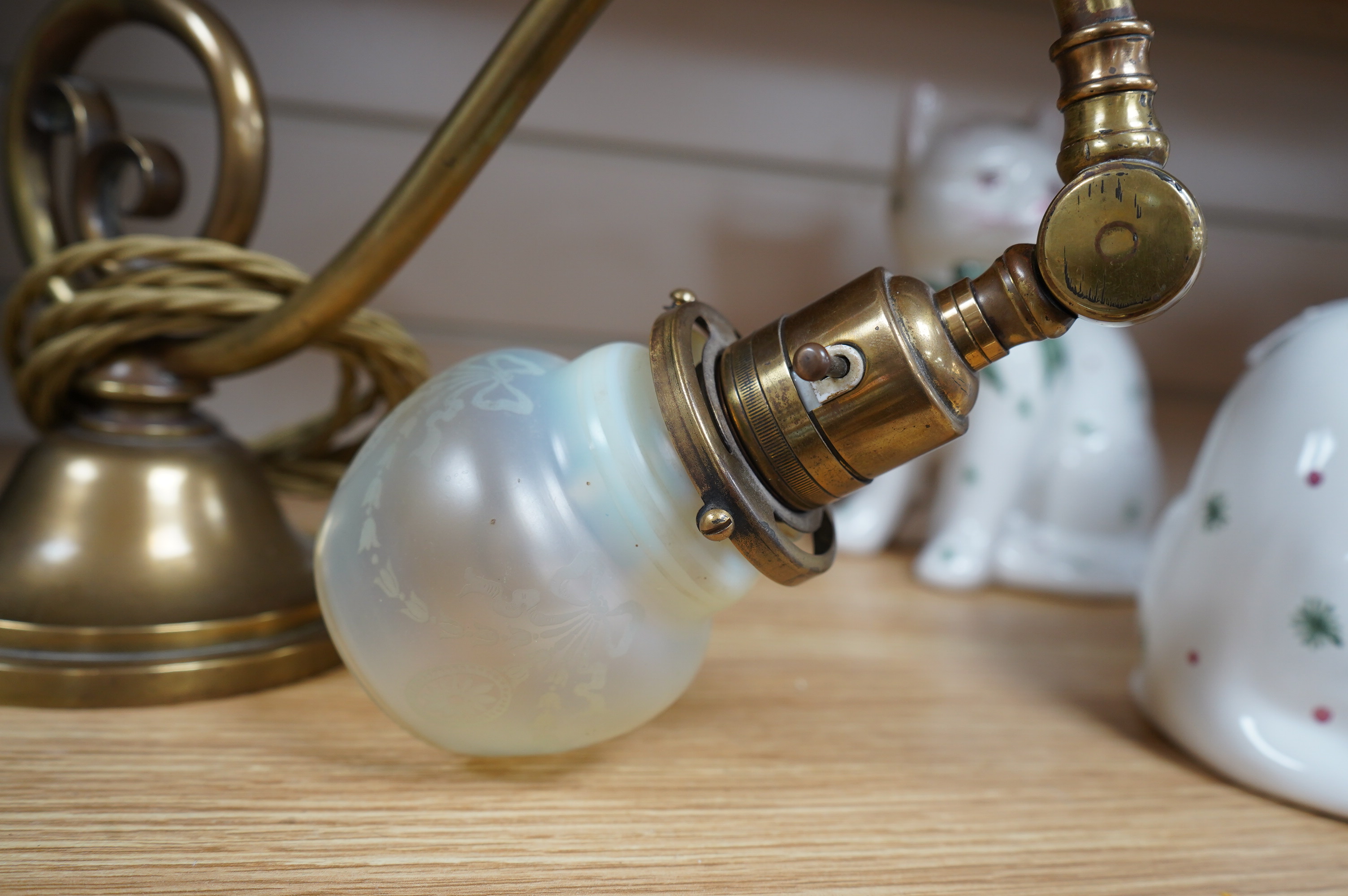 A brass piano lamp with original acid etched miniature Vaseline shade, circa early 20th century, wired, 20cm high, projection 43cm. Condition - fair to good, some minor nibbles to the shade